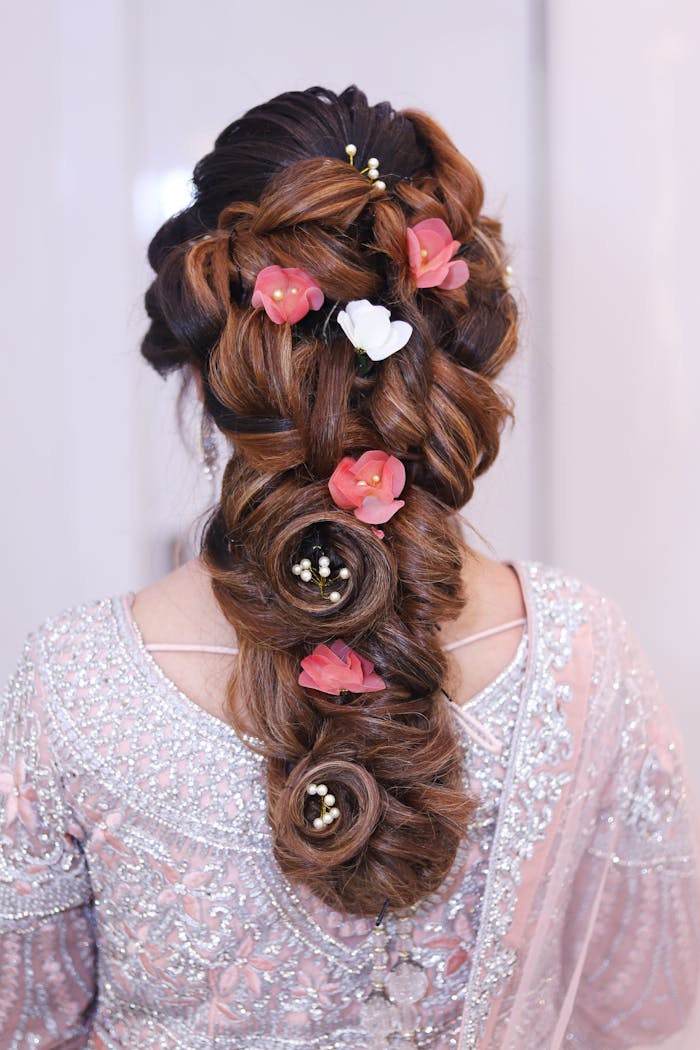 services-02 Stunning elegant braid adorned with pink and white flowers, perfect for bridal looks.